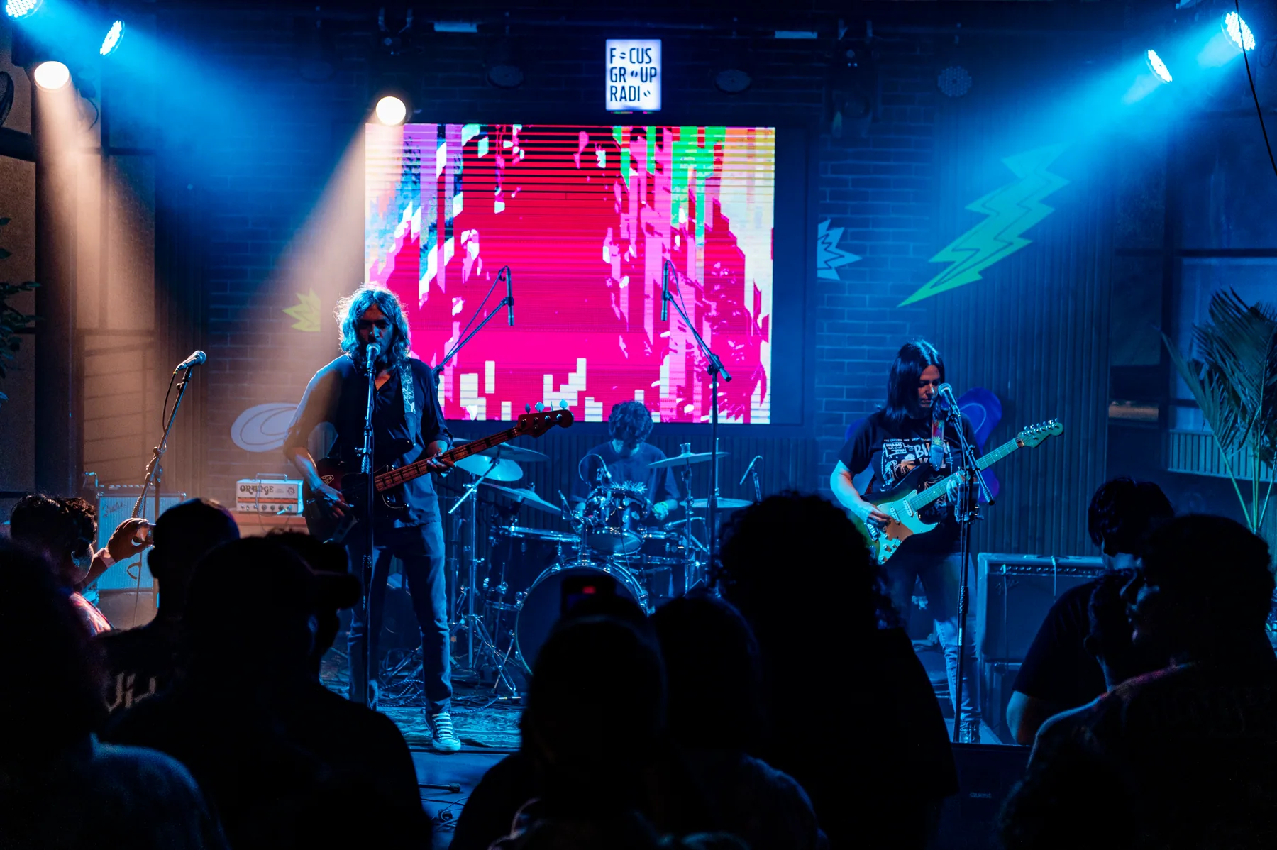 Band performing with projected collage visuals.