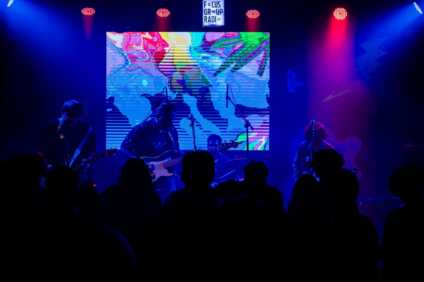 Wide view of a band and the festival screen.