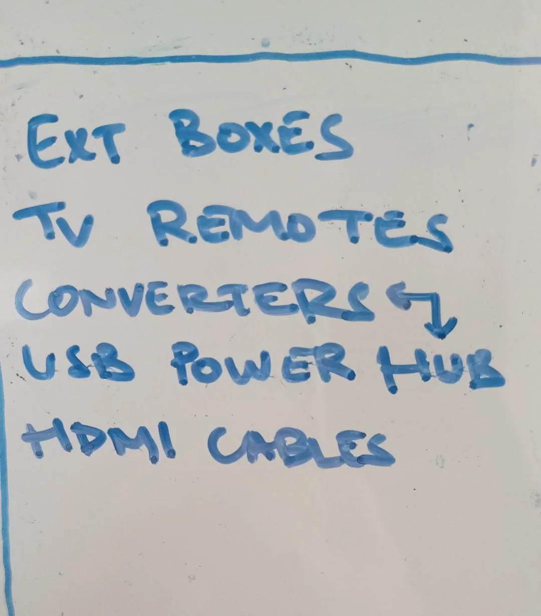 Whiteboard list of extension boxes, remotes, converters and cables.