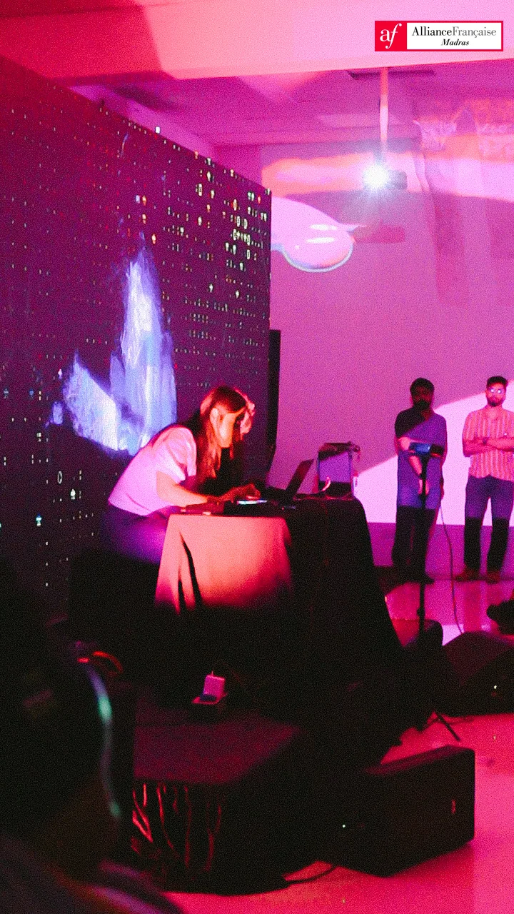 Performer surrounded by red projection.