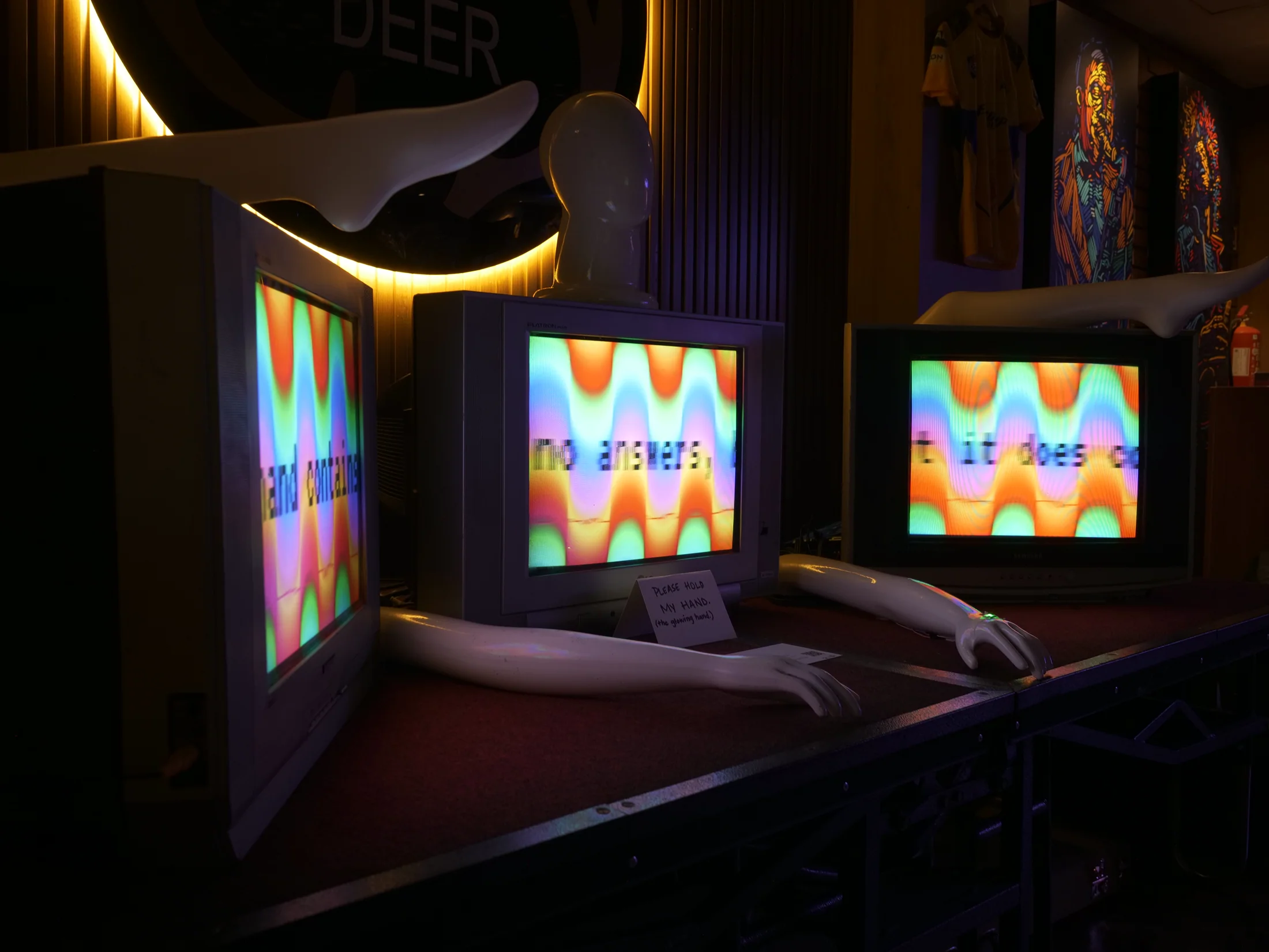 Three CRT televisions and mannequin limbs arranged for Have A Heart?.
