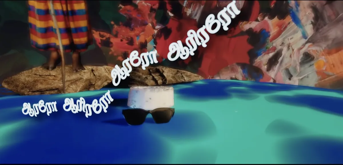 Opening frame of Thaalaatu: sunglasses resting above painted water, the first line of the lullaby across the image.